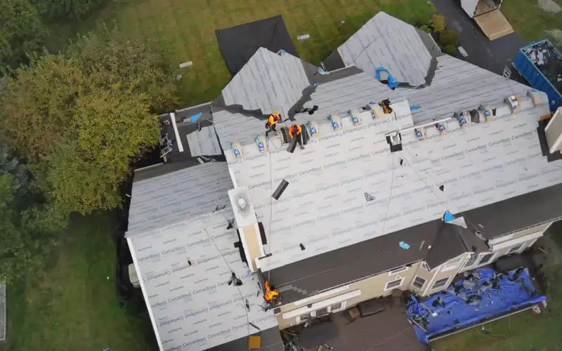 Overhead view of a roof replacement with underlayment installed
